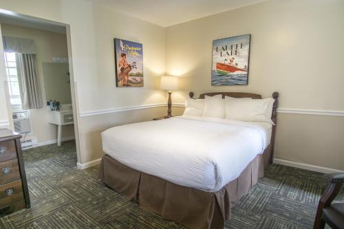 a bedroom with a large bed in a hotel room at The Yankee, Trademark Collection by Wyndham in Lenox