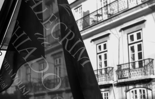 a flag in front of a building with balconies at Alecrim ao Chiado in Lisbon