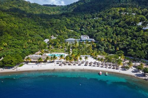 an aerial view of a resort on a beach at Sugar Beach, A Viceroy Resort in Soufrière