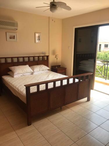 a bedroom with a large bed and a sliding glass door at Limni Pool House B in Larnaca