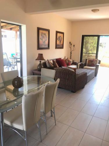 a living room with a glass table and a couch at Limni Pool House B in Larnaca