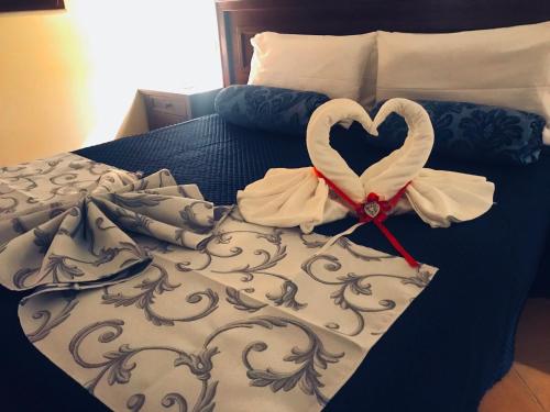 a bed with a heart made out of towels at Green Park Hotel & Residence in Bagnara Calabra