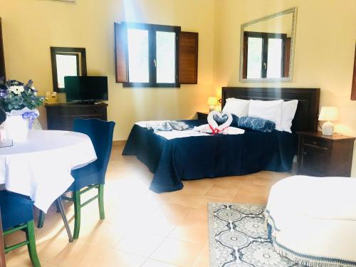 a bedroom with a bed with a swan on it at Green Park Hotel & Residence in Bagnara Calabra