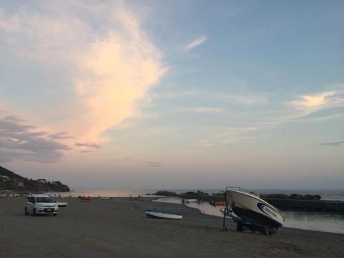 a boat parked on the beach with a truck at L'oasi di Giorgia in Cittadella del Capo