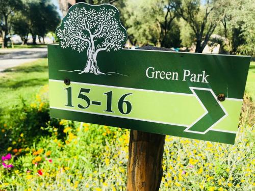a green park sign with a tree on it at Green Park Hotel & Residence in Bagnara Calabra