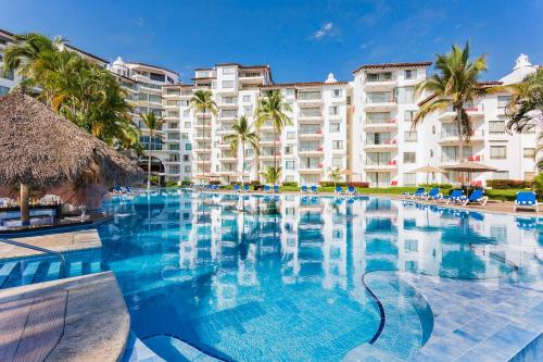 a large swimming pool in front of a hotel at Vamar Vallarta All Inclusive Marina & Beach Resort in Puerto Vallarta