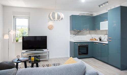 a living room with blue cabinets and a couch at Paulina in Dubrovnik