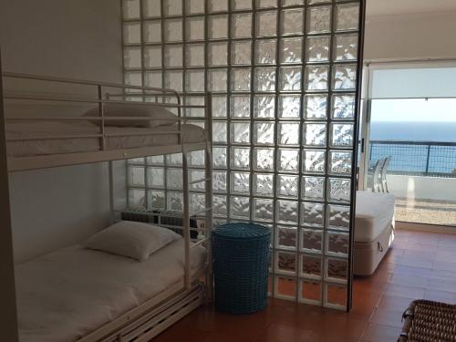 セジンブラにあるSesimbra Terrasseのベッドルーム1室(二段ベッド付)が備わり、海の景色を望めます。