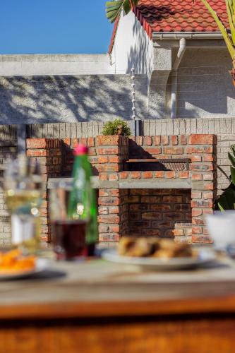 a brick fireplace with plates of food on a table at King Guest Lodge in Port Elizabeth