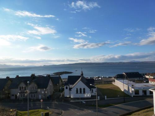 a town with houses and the ocean in the background at West Highland Hotel in Mallaig