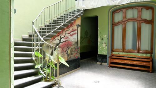 a staircase in a building with a painting on the wall at Azcami Boutique Hotel in Puebla
