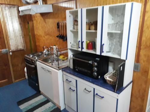 a kitchen with a sink and a stove at Depto. Altos de Tenglo in Puerto Montt