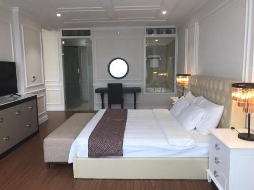 a bedroom with a bed and a desk and a television at Dai Viet Hotel in Thanh Hóa