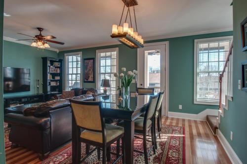 a dining room with a table and a couch at Rick's Downtown Nashville Guest House in Nashville