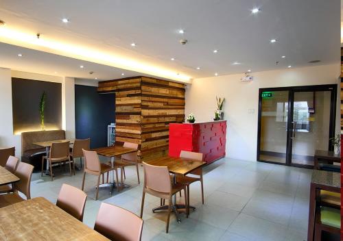 a restaurant with tables and chairs in a room at Fersal Hotel Kalayaan, Quezon City in Manila