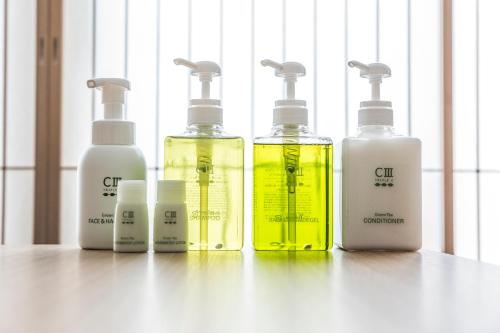 a group of four bottles sitting on a table at Tomoya Residence Hotel Kyoto in Kyoto