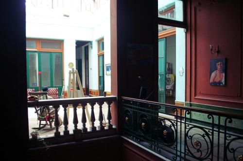 a balcony of a building with a window at El Secreto Casa Art in Montevideo