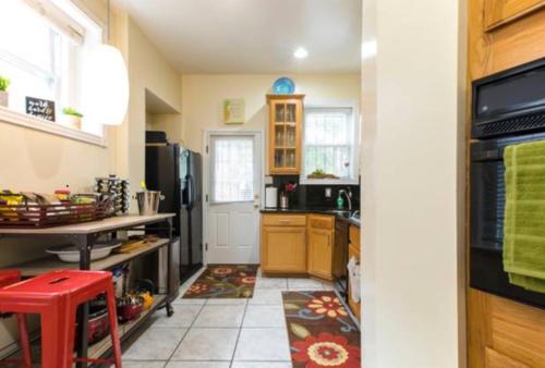 a kitchen with a refrigerator and a stove top oven at Convention Center/Logan Circle Large Cozy House. in Washington