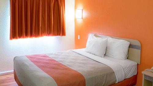 a bedroom with a bed with a colorful blanket at Motel 6-Seymour, IN - North in Seymour