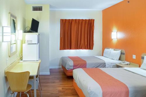 a hotel room with two beds and a desk at Motel 6-Seymour, IN - North in Seymour