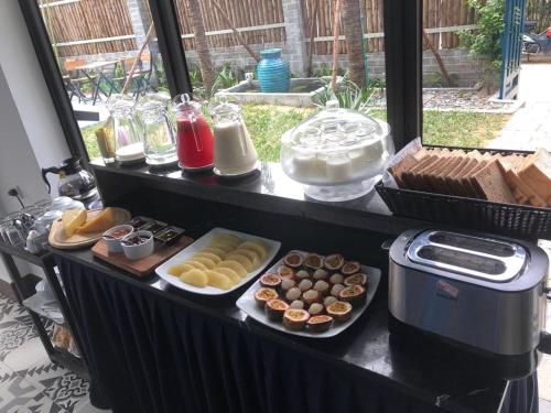 a table with different types of food on it at The Blue Alcove Hotel in Hoi An