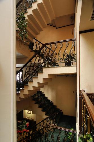 a spiral staircase in a building with a plant at Hotel Diplomat Residency in New Delhi