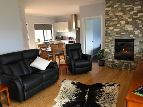 a living room with a couch and a fireplace at Manna Hill Farm in West Kentish