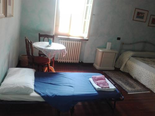 a bedroom with a bed and a table and a window at B&B da Michela in Perugia