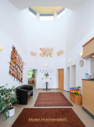 a living room with a couch and a table at Motel Hormersdorf in Hormersdorf