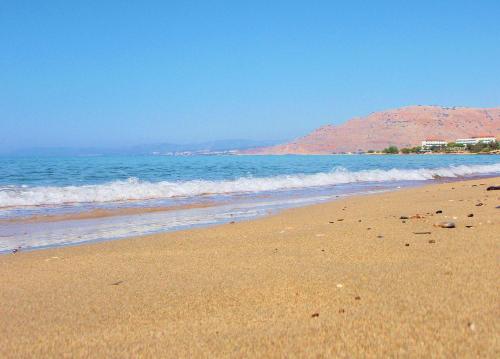 a sandy beach with the ocean in the background at Villa CostaMare - enjoy lazy days on the private Pool-Jacuzzi in Pefki Rhodes