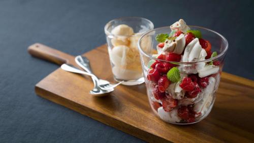 a glass cup with fruit and whipped cream on a wooden tray at Grand Hyatt Tokyo in Tokyo