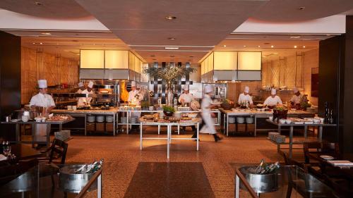 a group of chefs in a kitchen preparing food at Grand Hyatt Tokyo in Tokyo