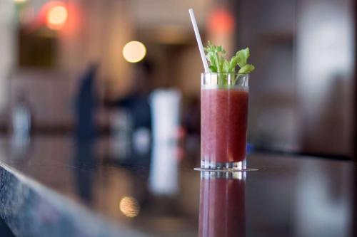 a red drink with a straw in a glass on a counter at Hyatt Place Phoenix/ Mesa in Mesa