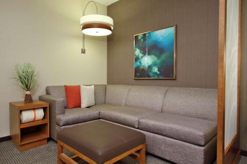 a living room with a couch and a table at Hyatt Place Houston/Katy in Katy