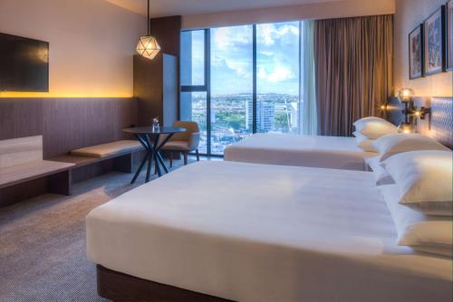 a hotel room with two beds and a window at Hyatt Regency Andares Guadalajara in Guadalajara