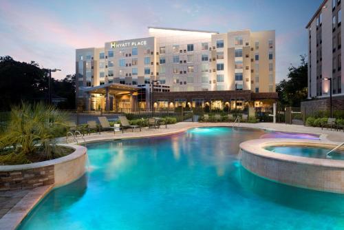 a large swimming pool in front of a hotel at Hyatt Place Biloxi in Biloxi