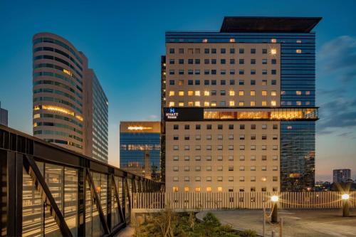 a tall building in a city with tall buildings at Hyatt House Mexico City Santa Fe in Mexico City