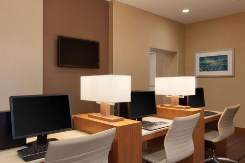 a room with two desks with computer monitors and chairs at Hyatt Place St. Louis/Chesterfield in Chesterfield