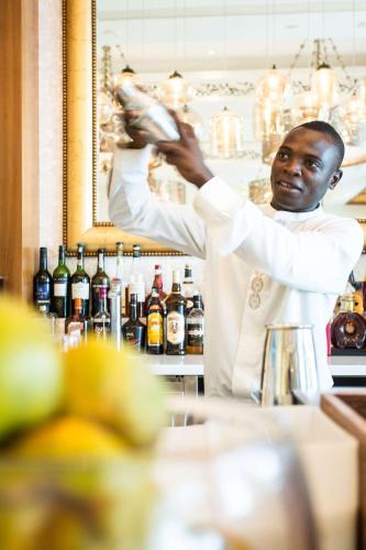 a chef standing behind a counter in a bar at Park Hyatt Zanzibar in Zanzibar City