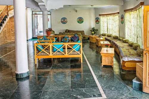 a living room with couches and tables in it at The Nature Residency - A Riverside Resort in Leh in Leh