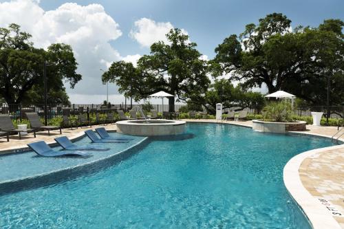 a swimming pool with lounge chairs and a fountain at Hyatt Place Biloxi in Biloxi