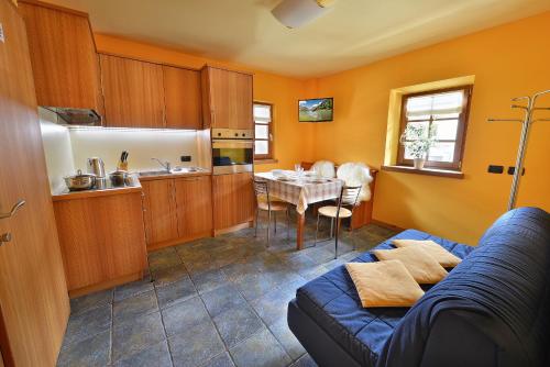 a living room with a blue couch and a table at Chalet Matteo in Livigno