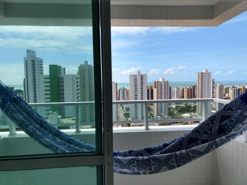 a window with a view of a city skyline at Essencial Manaíra in João Pessoa