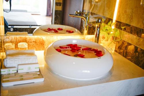 a white bowl on a counter in a bathroom at Green Hadong Hotel in Hà Ðông