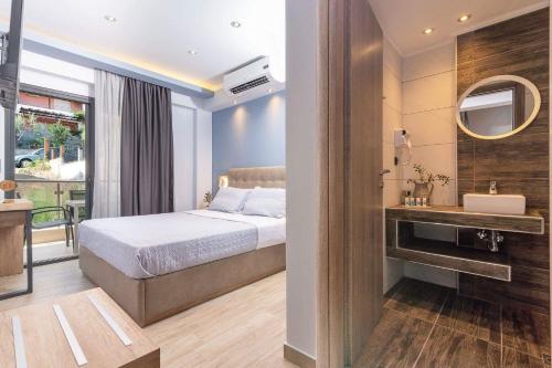 a bedroom with a bed and a bathroom with a mirror at Oasis in Sarti