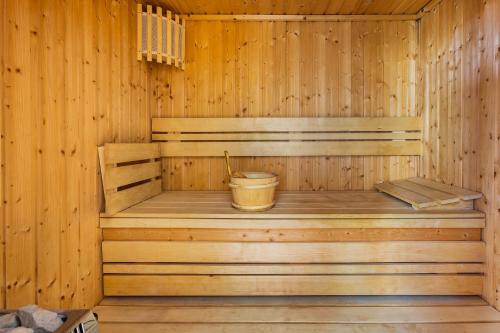 a wooden sauna with a bucket in it at Hotel Kriopigi in Kriopigi