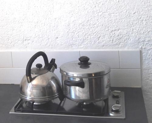 a tea kettle on top of a stove at Elounda Island Villas in Elounda