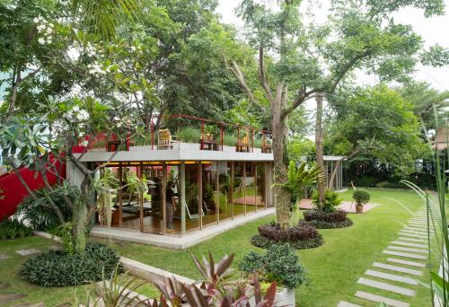 a house in the middle of a garden with trees at Let's Sea Hua Hin Al Fresco Resort in Hua Hin