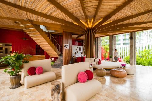 a lobby with white chairs and red pillows at Let's Sea Hua Hin Al Fresco Resort in Hua Hin
