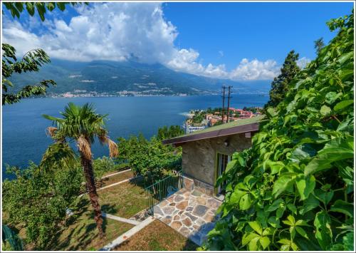 a house on a hill with a view of the water at Fantastica Casa Poppo in Bellano